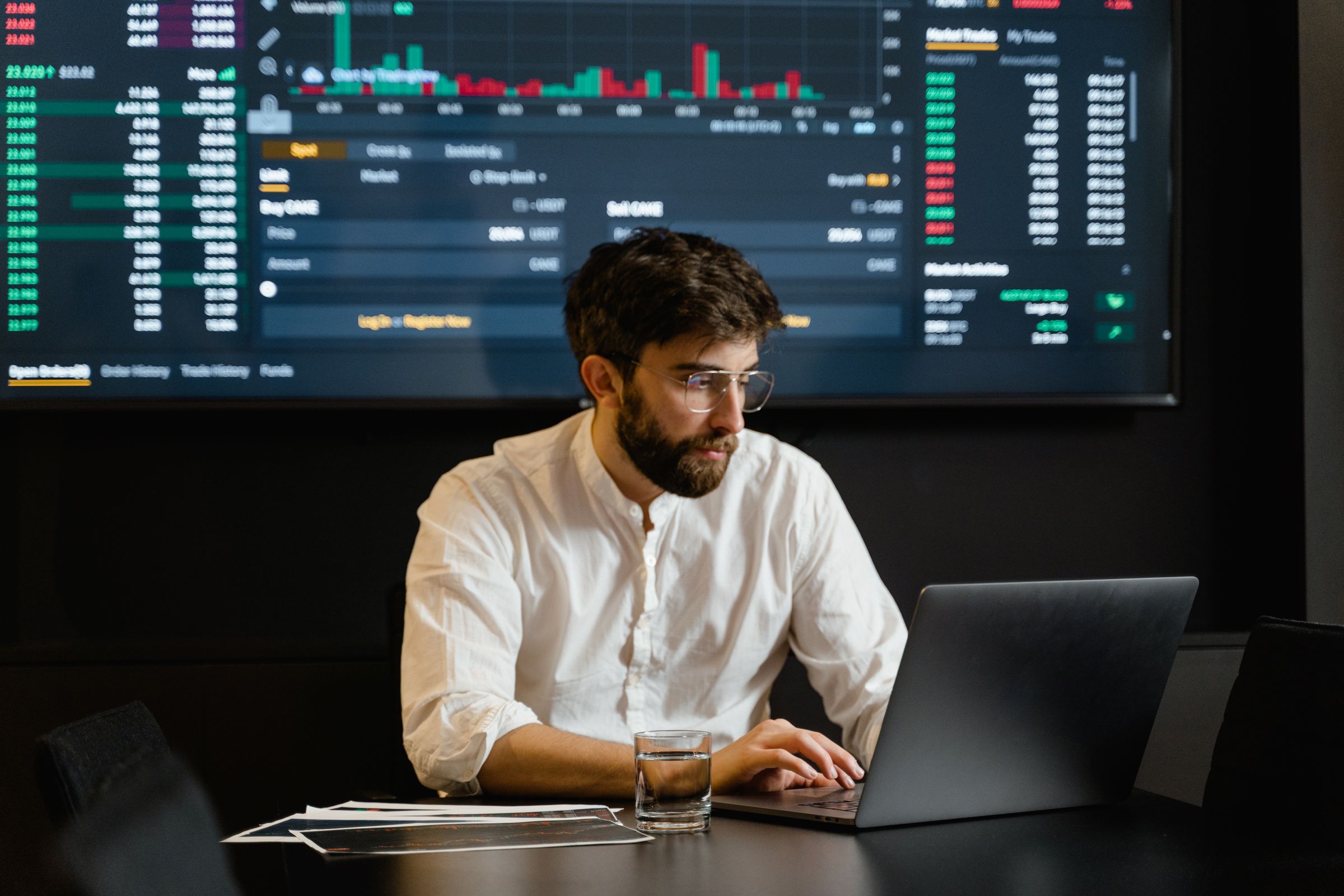 Developer working at night in front of live data screens